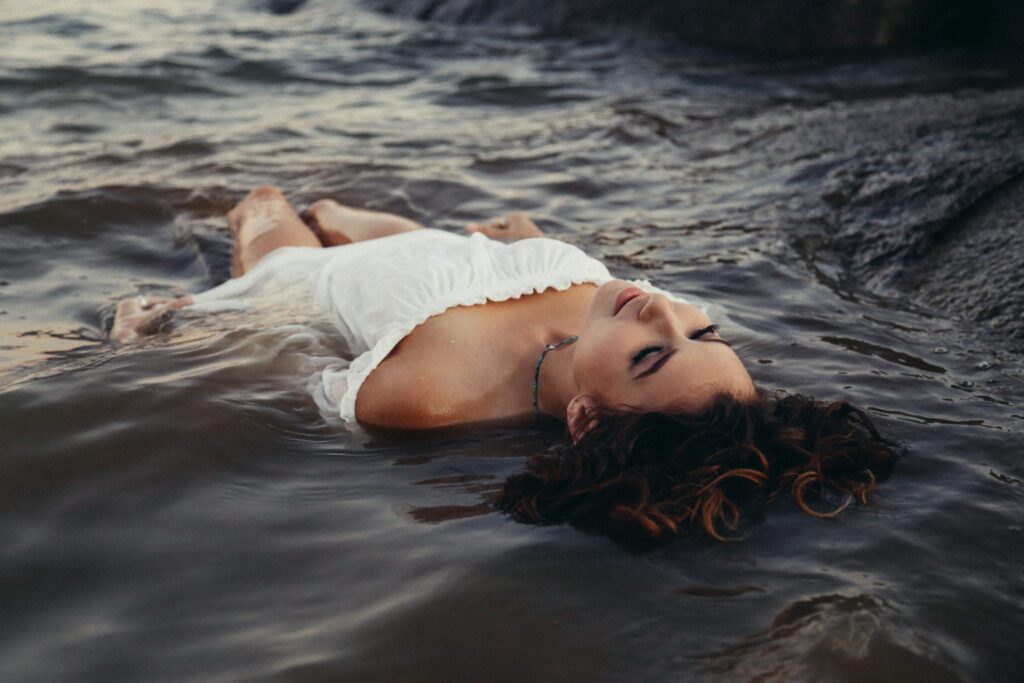 Women lying in the shallow water