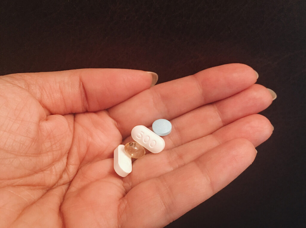 women holding different supplements