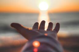 hand reaching out to the sun