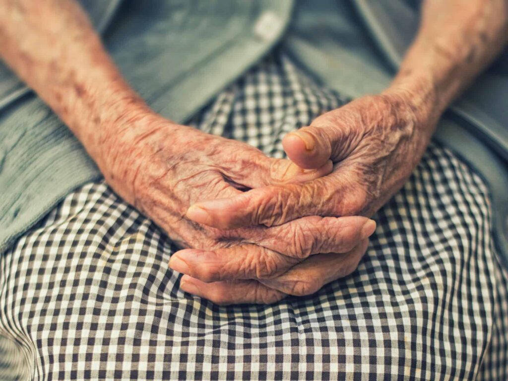 old woman hands on lap